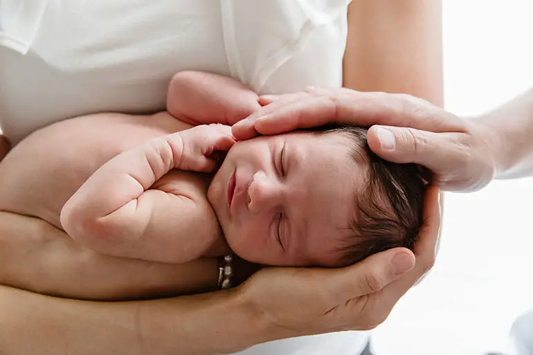 Sleepy and content newborn baby - an example of Melbourne Newborn Photography.