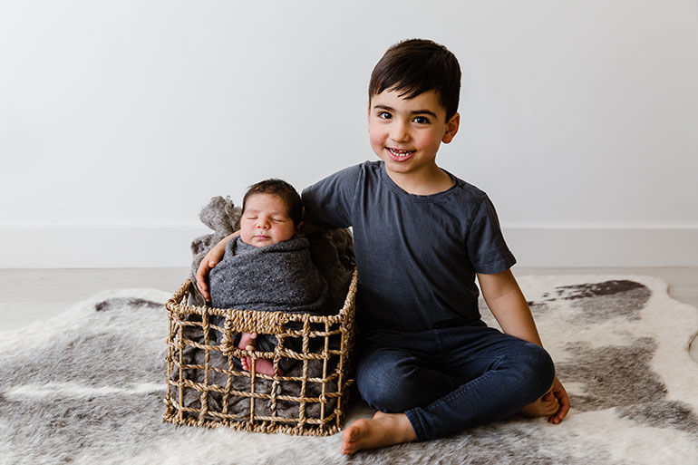 Siblings in dark colours - Ideas of what to wear for newborn photos.